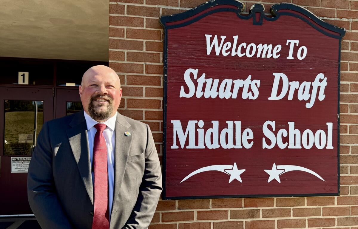 Steve Hom standing next to the Stuarts Draft Middle School sign.