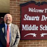 Steve Hom standing next to the Stuarts Draft Middle School sign.