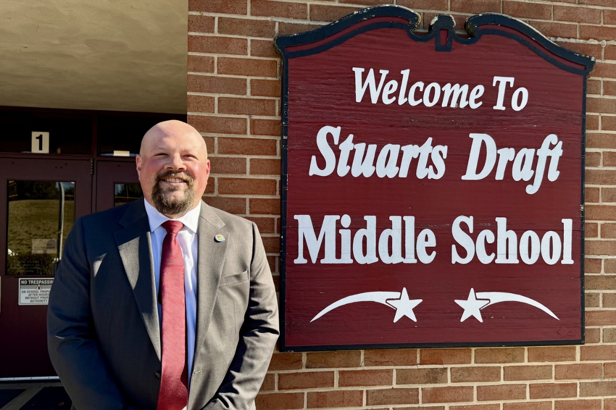 Steve Hom standing next to the Stuarts Draft Middle School sign.