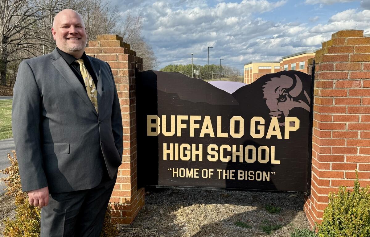 Jesse Ault stands with the Buffalo Gap High School sign.