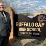 Jesse Ault stands with the Buffalo Gap High School sign.