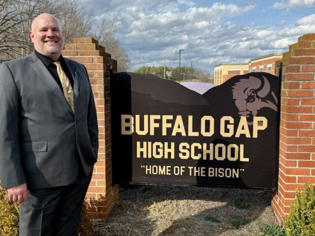 Jesse Ault stands with the Buffalo Gap High School sign.