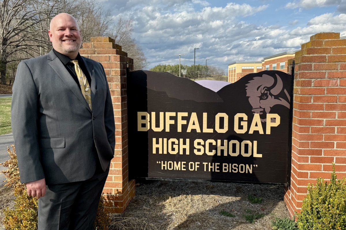 Jesse Ault stands with the Buffalo Gap High School sign.