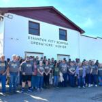 Bus drivers stand in front of the new Staunton City Schools Operation Center building.