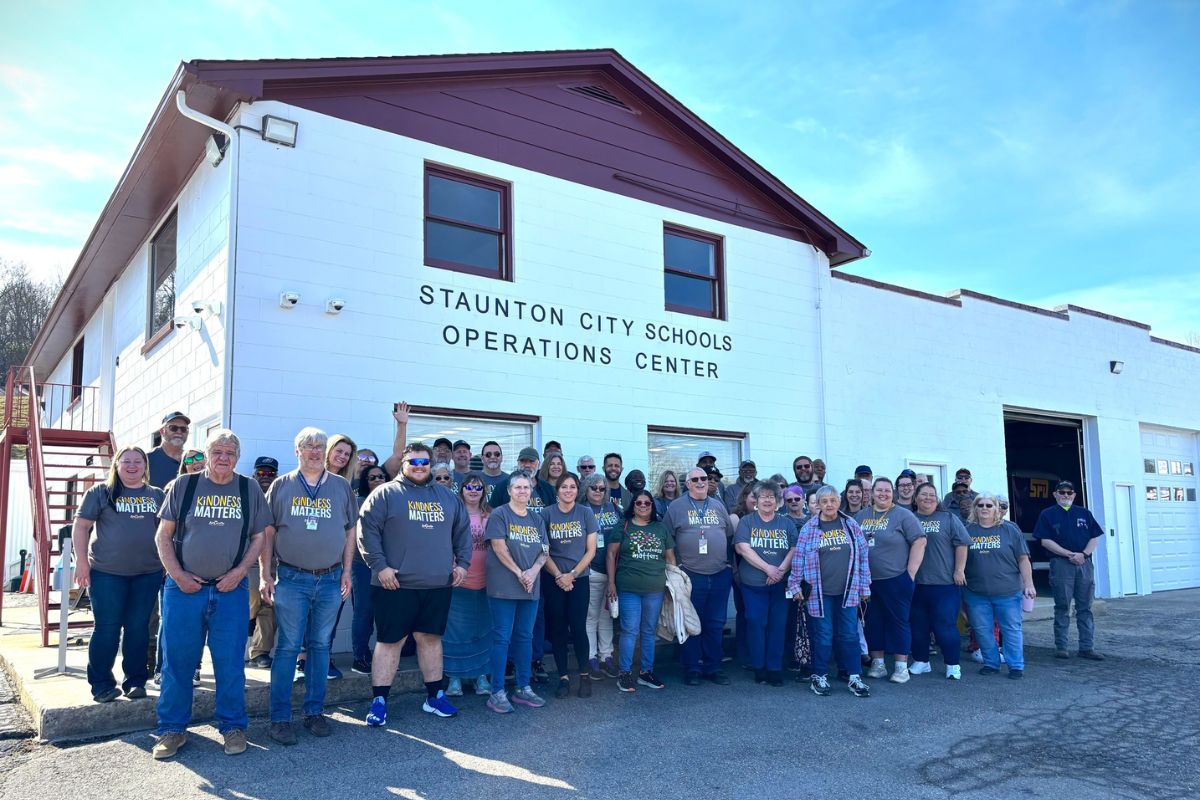 Bus drivers stand in front of the new Staunton City Schools Operation Center building.