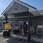 The owners of Highest Roofing cut the ribbon at their new location.