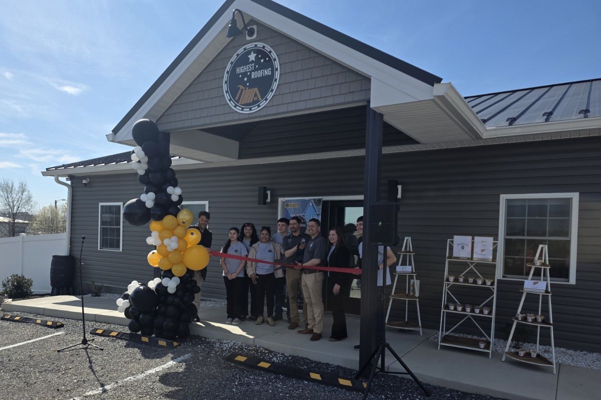 The owners of Highest Roofing cut the ribbon at their new location.