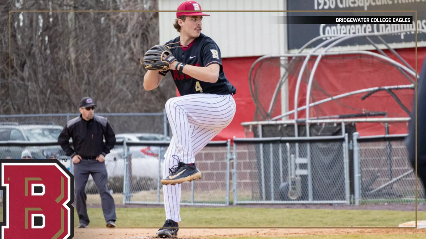 Baseball pitcher in mid-windup on the mound, wearing a black uniform and striped pants, with a large B logo in the foreground.