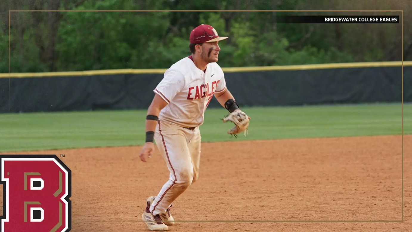 Baseball player in a white Eagles uniform on the infield, ready to field, with Bridgewater College Eagles branding visible.