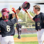 Baseball players in black jerseys celebrate with a high-five on the field, Bridgewater College Eagles logo visible in the scene.