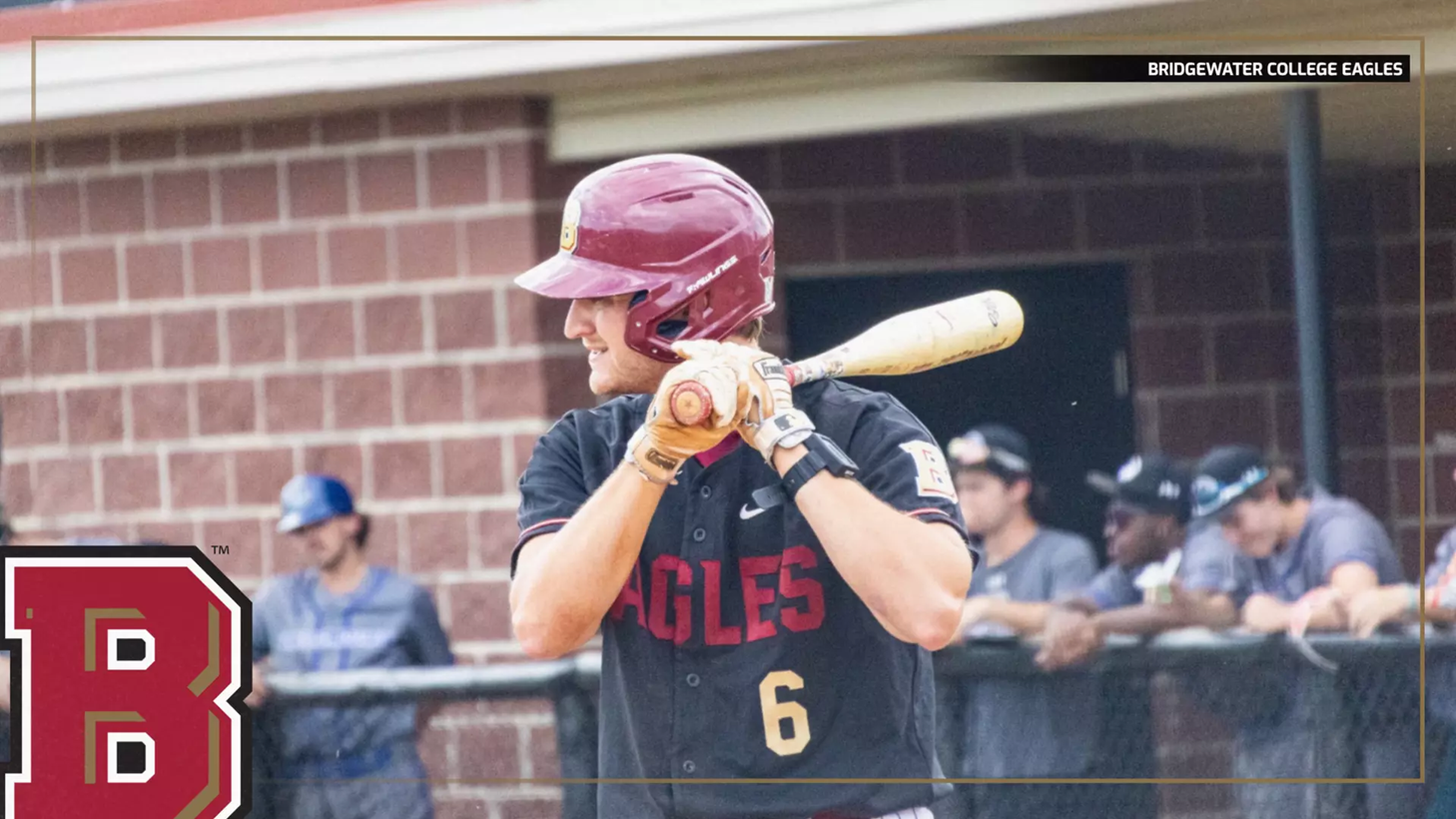 Baseball player in a maroon helmet and black Eagles jersey (number 6) holds a bat ready to swing at the plate.