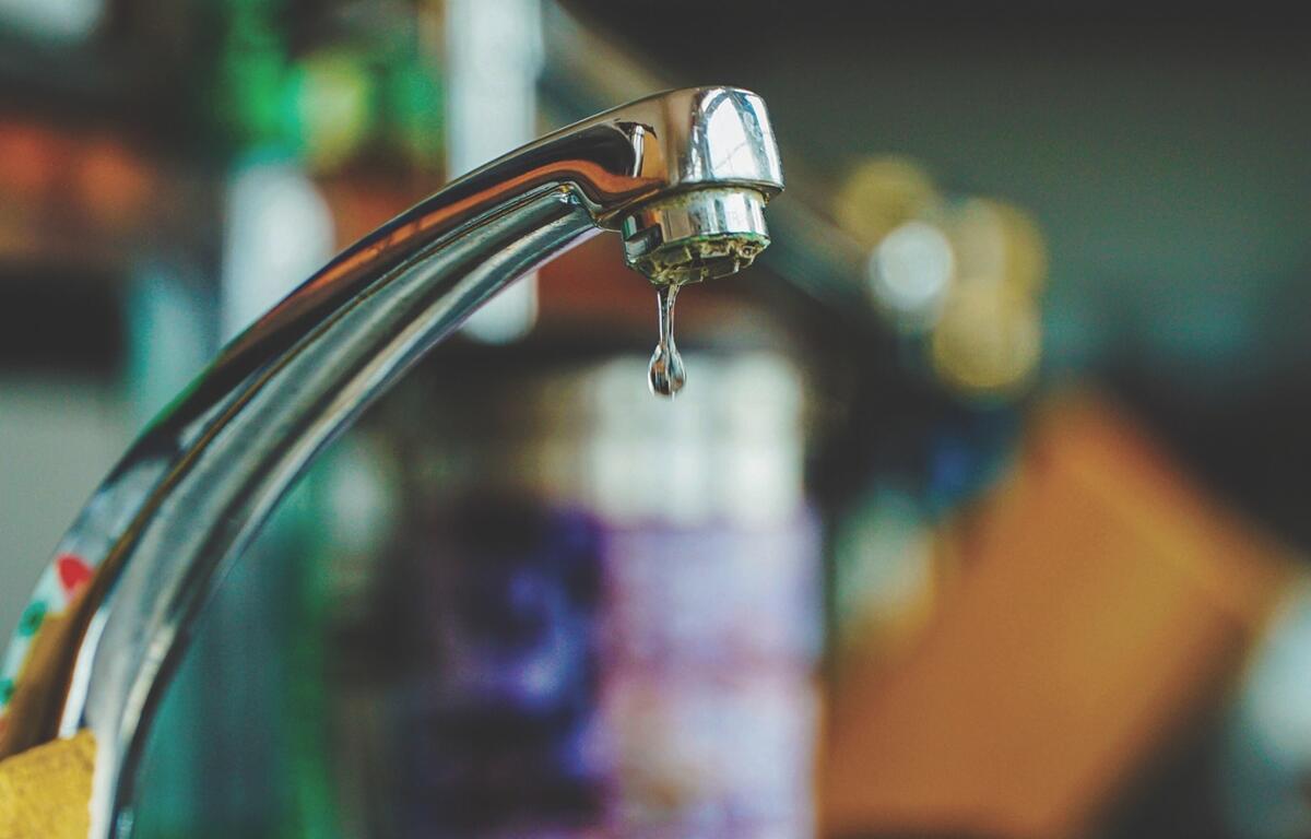 Up close of a water faucet.