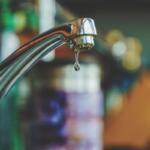 Up close of a water faucet.