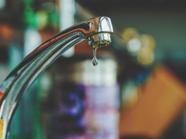 Up close of a water faucet.