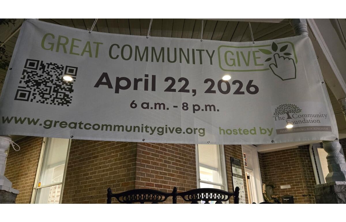Banner promoting 'Great Community Give' on a brick porch displaying April 22, 2026 and a QR code.