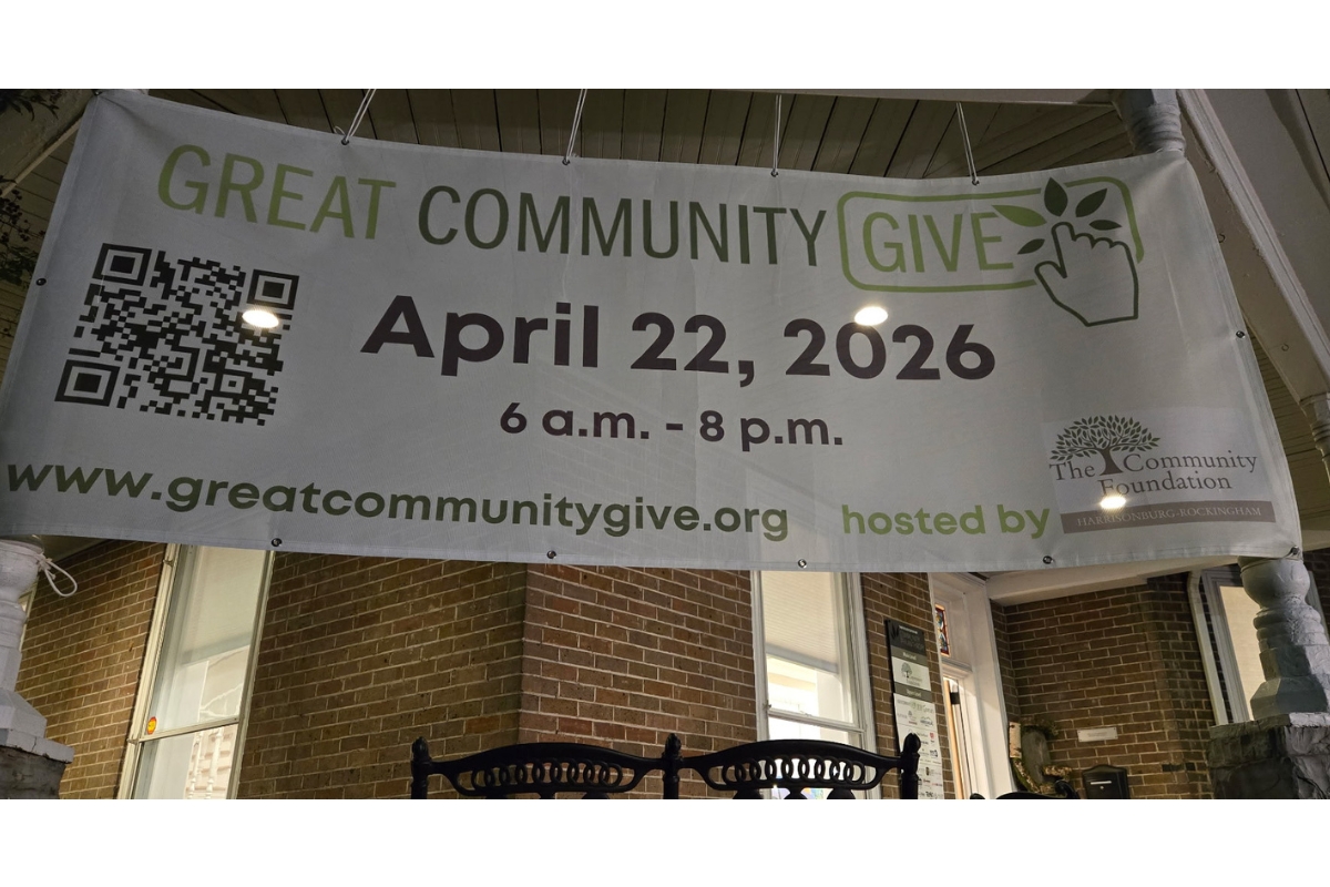 Banner promoting 'Great Community Give' on a brick porch displaying April 22, 2026 and a QR code.
