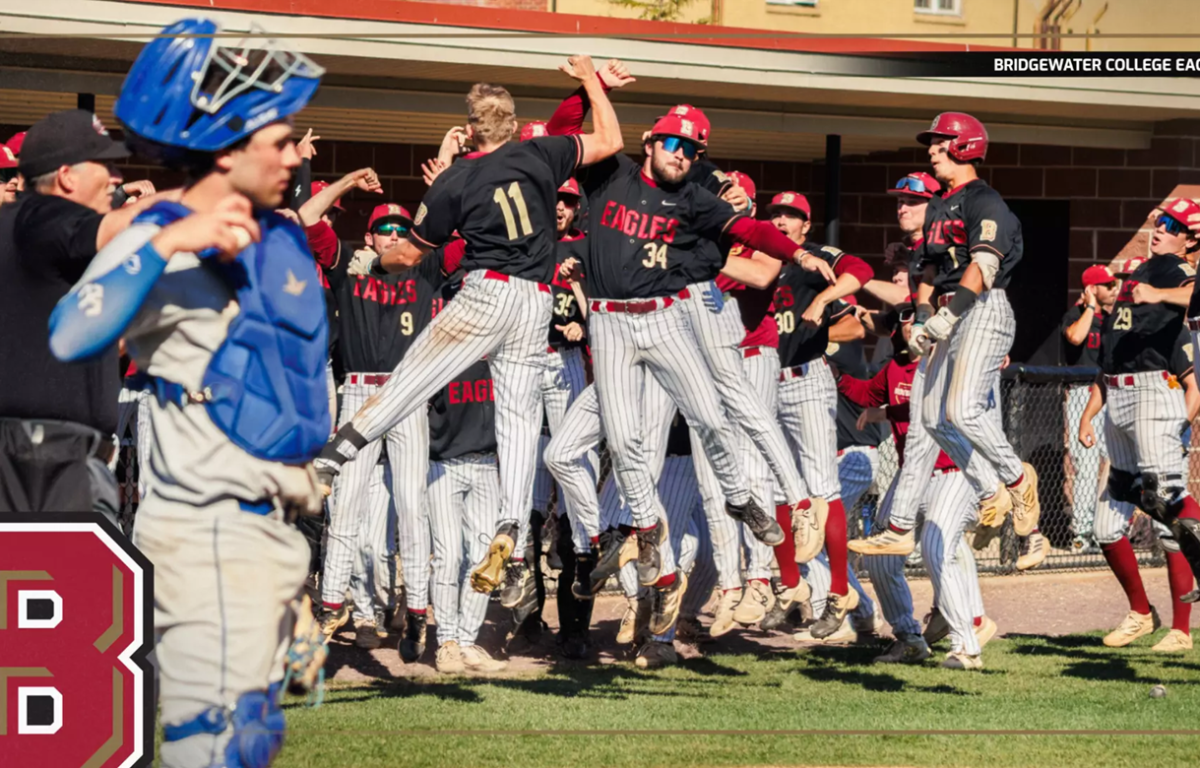 Bridgewater College Eagles baseball team celebrating on the field, players in black jerseys jumping with arms raised after a win.