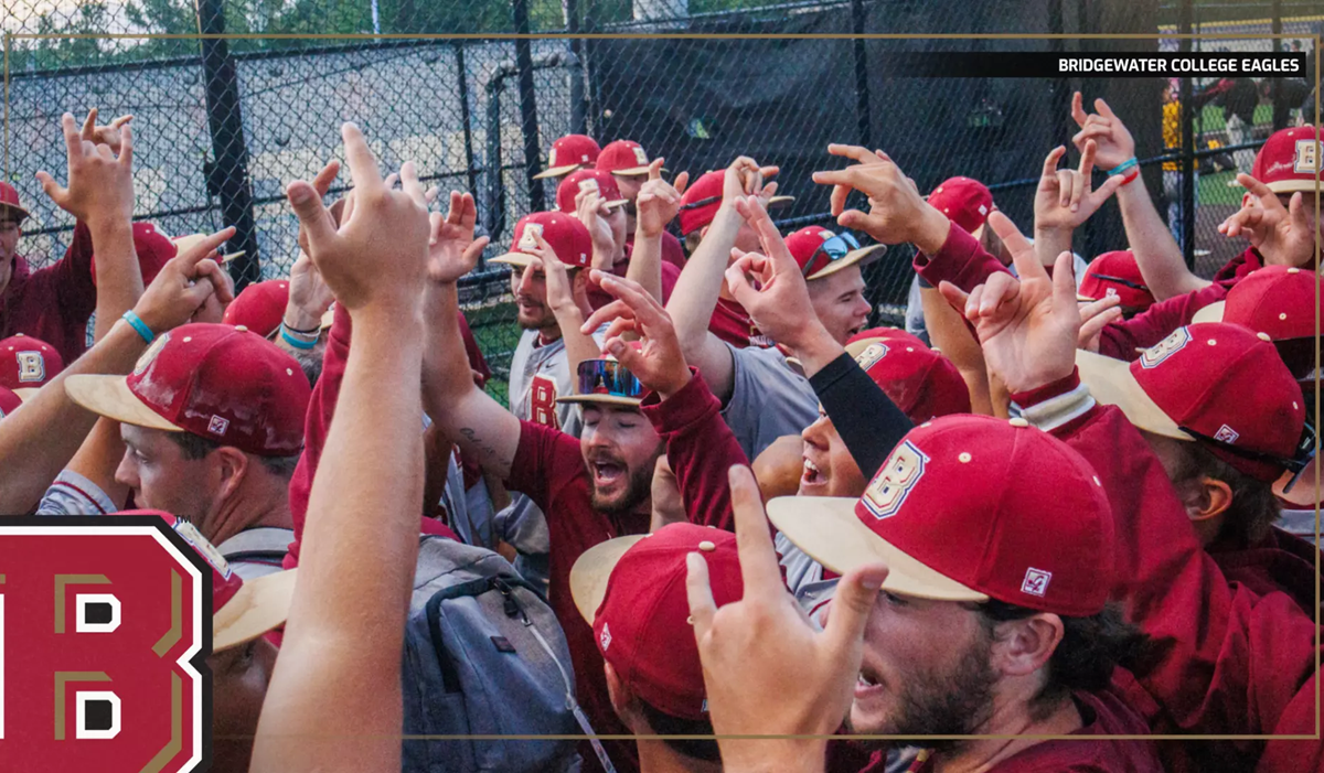Bridgewater College Eagles baseball players celebrate with raised hands in a huddle on the field, a large B logo visible on the left.
