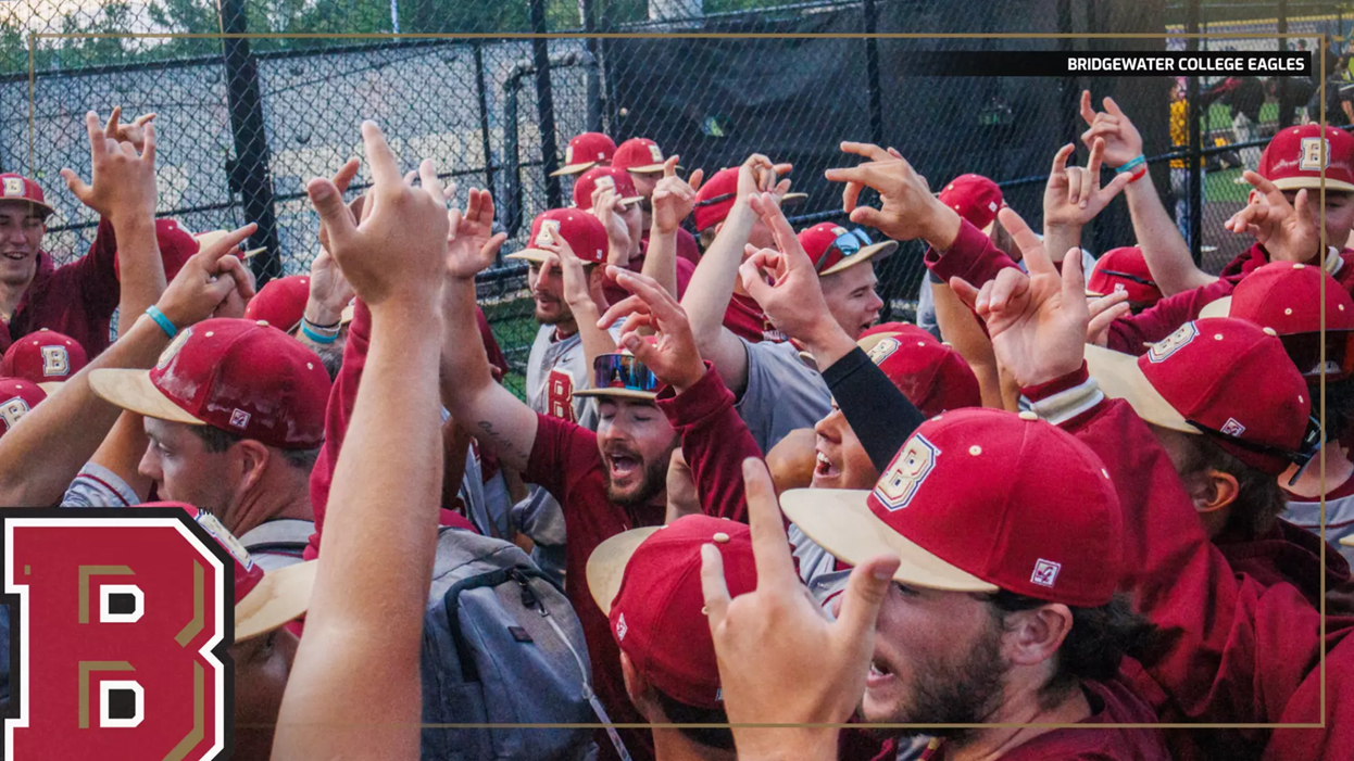 Bridgewater College Eagles baseball players celebrate with raised hands in a huddle on the field, a large B logo visible on the left.
