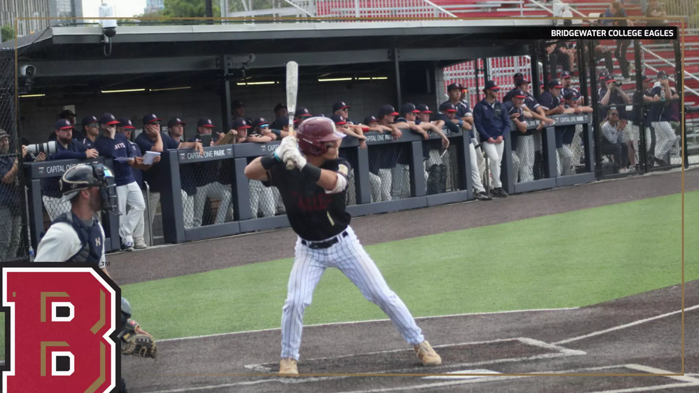 Baseball batter in black swings at home plate as teammates watch from the dugout; Bridgewater College Eagles insignia bottom-left.