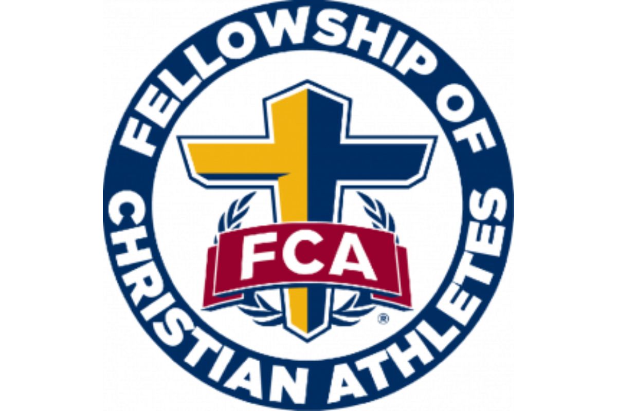 FCA logo: circular emblem with a blue-and-yellow cross, laurel leaves, and a red FCA banner, surrounding the words 'Fellowship of Christian Athletes'.