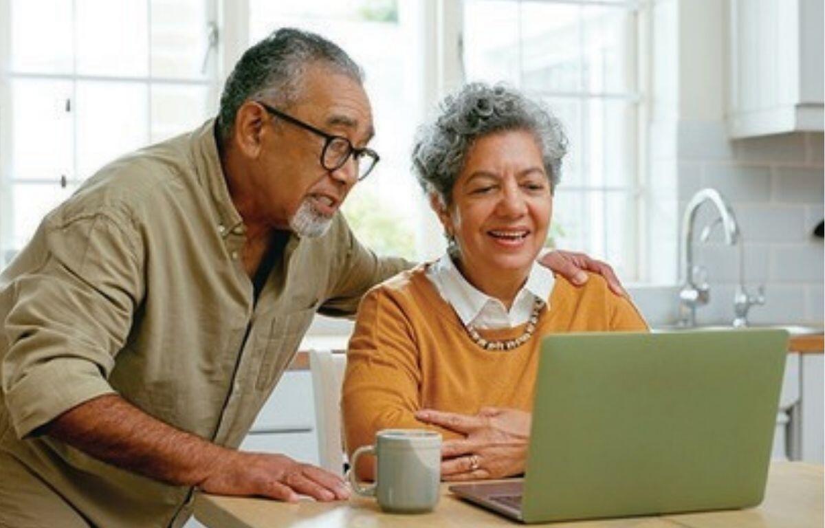 An older couple on their laptop talking to family members
