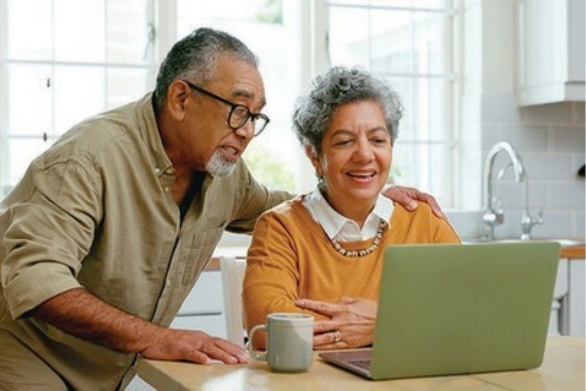 An older couple on their laptop talking to family members