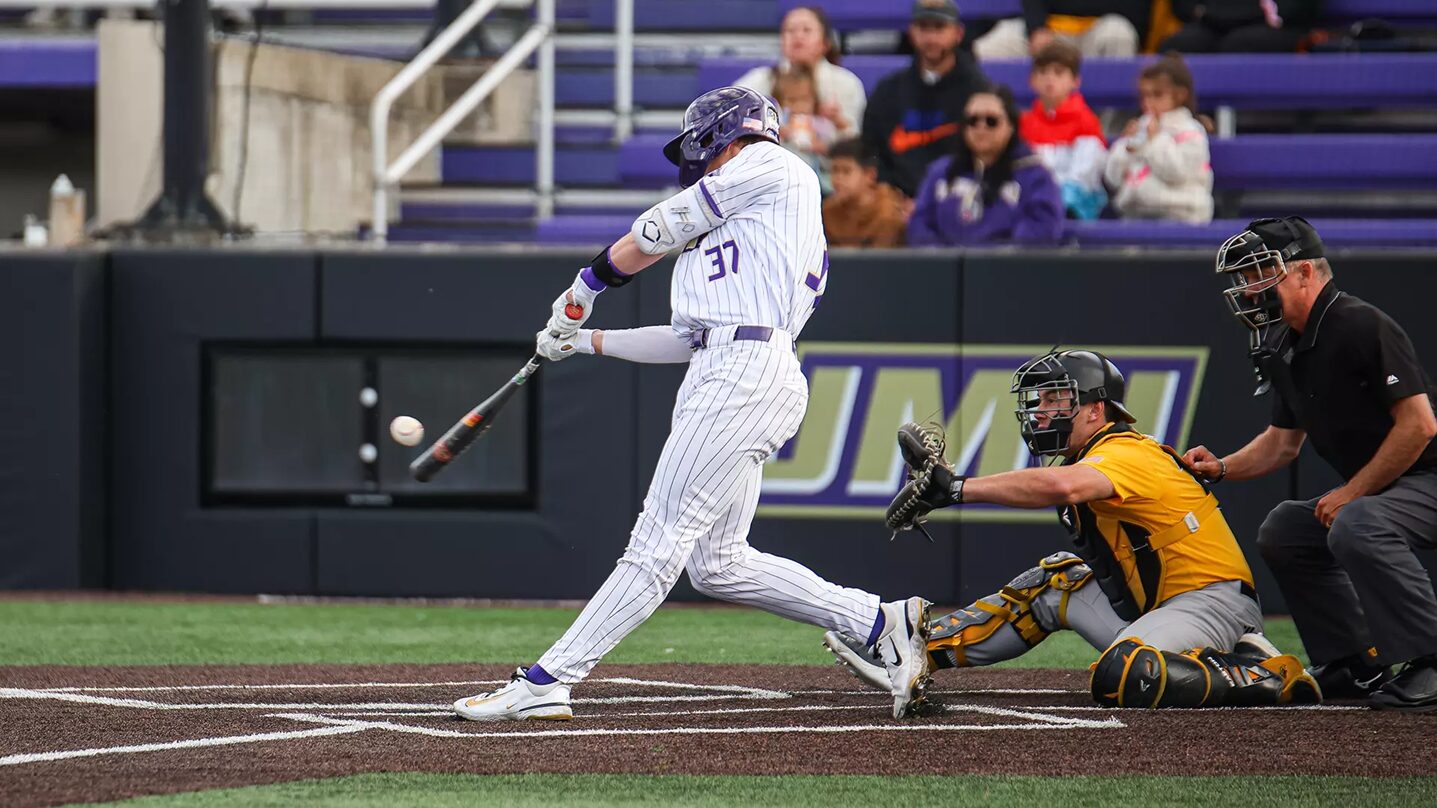 Baseball batter in white pinstripe uniform (-number 37) swings at a pitch as the catcher in yellow crouches behind home plate with an umpire nearby.