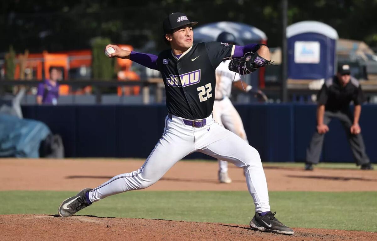 Baseball pitcher in a black jersey with OVU logo delivering a pitch from the mound.