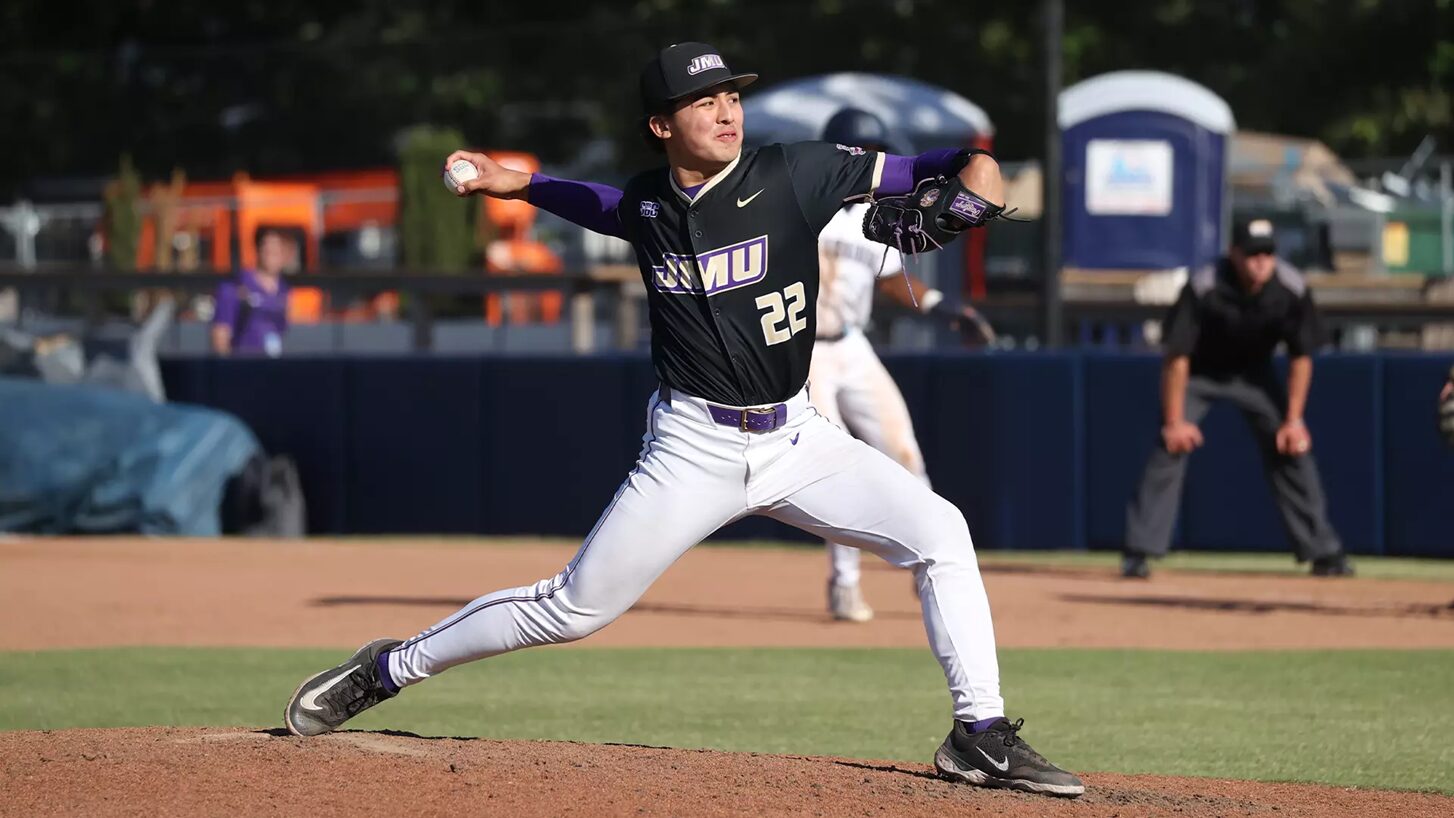 Baseball pitcher in a black jersey with OVU logo delivering a pitch from the mound.
