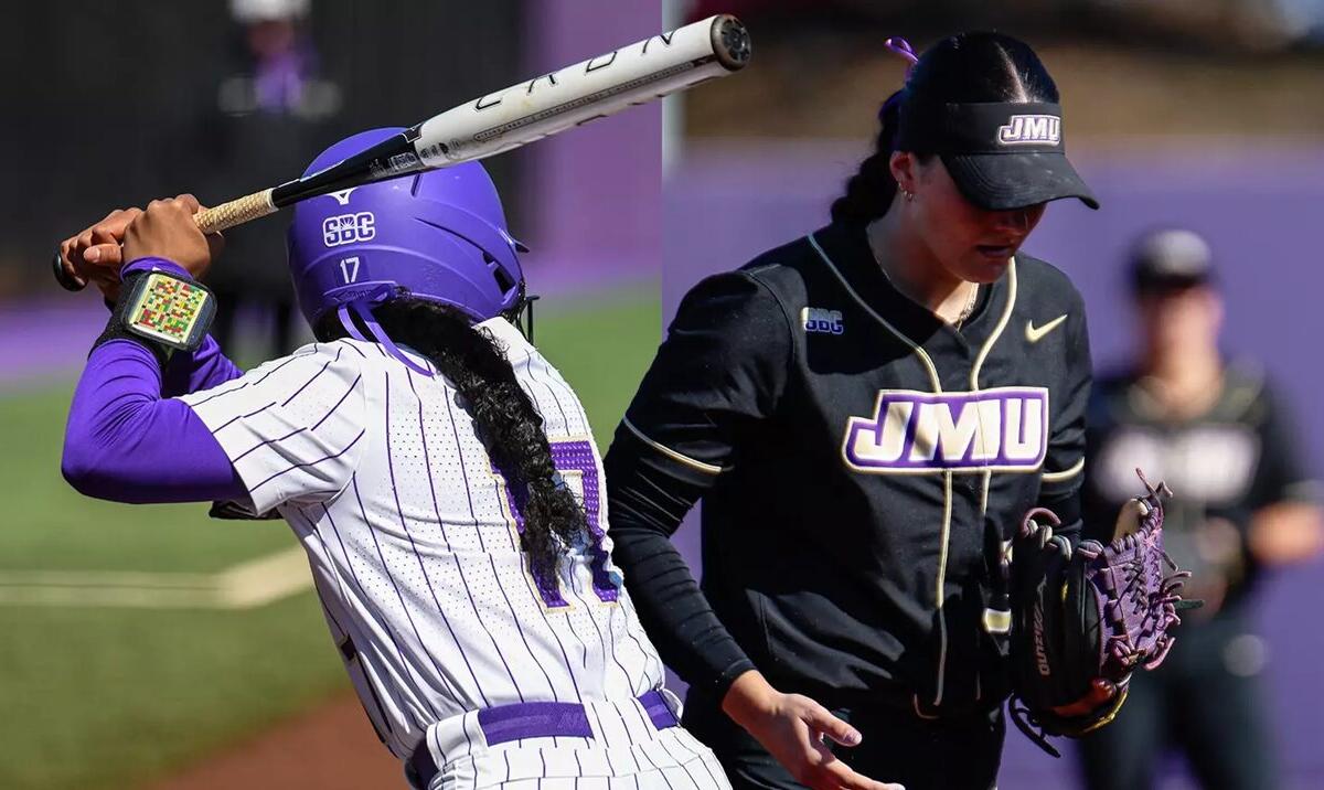 Two softball players collide at the plate: a purple-helmed batter swings while a black-uniform fielder closes in.