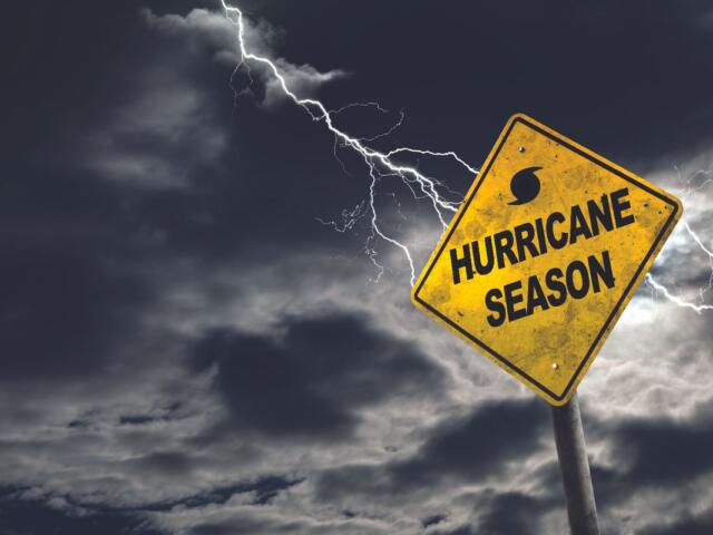 Hurricane season sign with storm clouds in the background