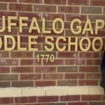 Tammy Chambers standing in front of the logo for Buffalo Gap Middle School