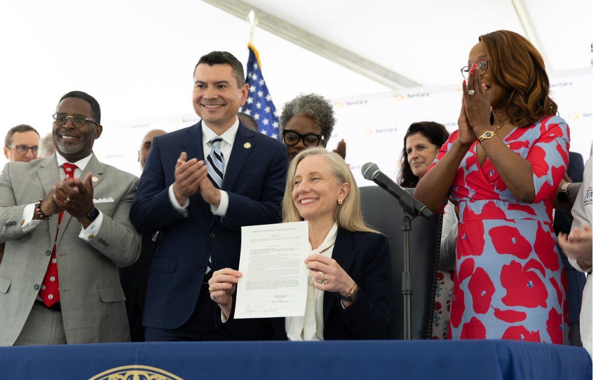 Governor Abigail Spanberger posing after signing legislation