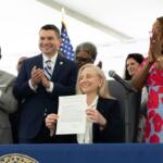 Governor Abigail Spanberger posing after signing legislation