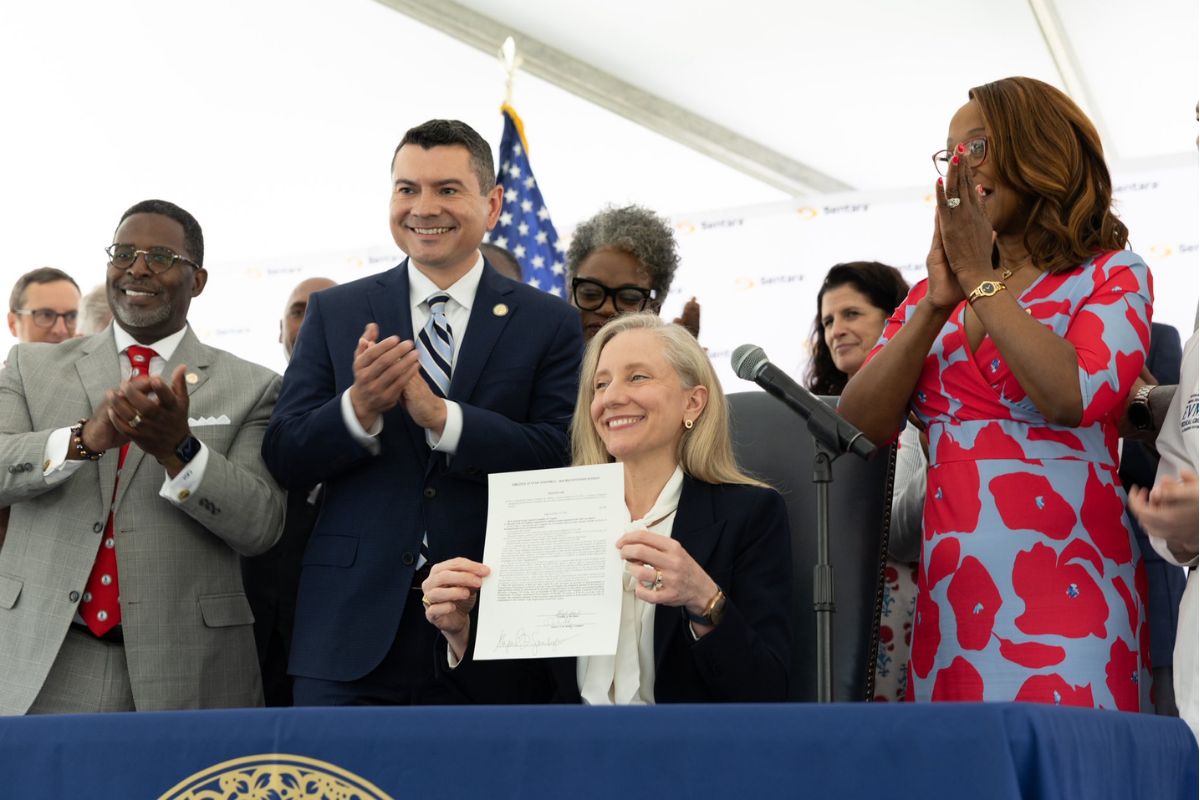 Governor Abigail Spanberger posing after signing legislation