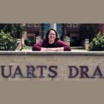 Lauren Brenneman posing next to the Stuarts Draft Elementary School sign