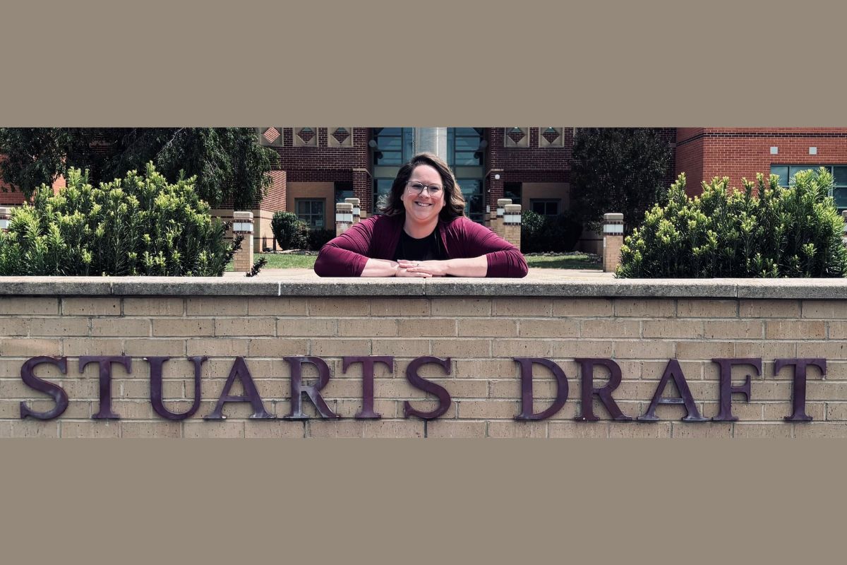 Lauren Brenneman posing next to the Stuarts Draft Elementary School sign