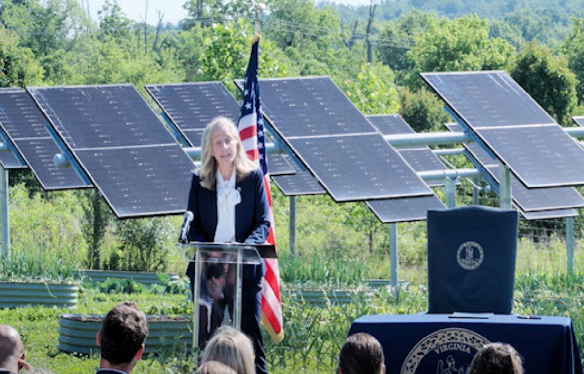 Governor Abigail Spanberger speaking in front of solar panels