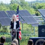 Governor Abigail Spanberger speaking in front of solar panels