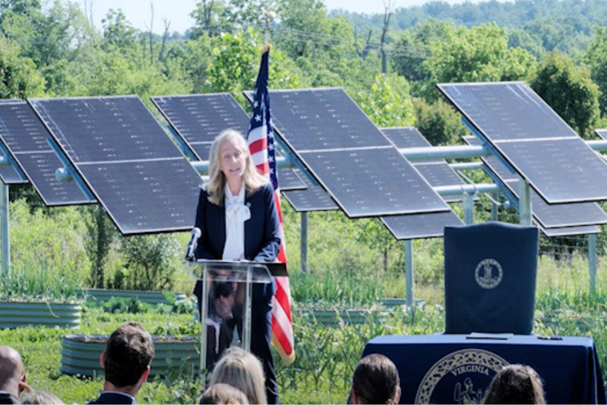 Governor Abigail Spanberger speaking in front of solar panels