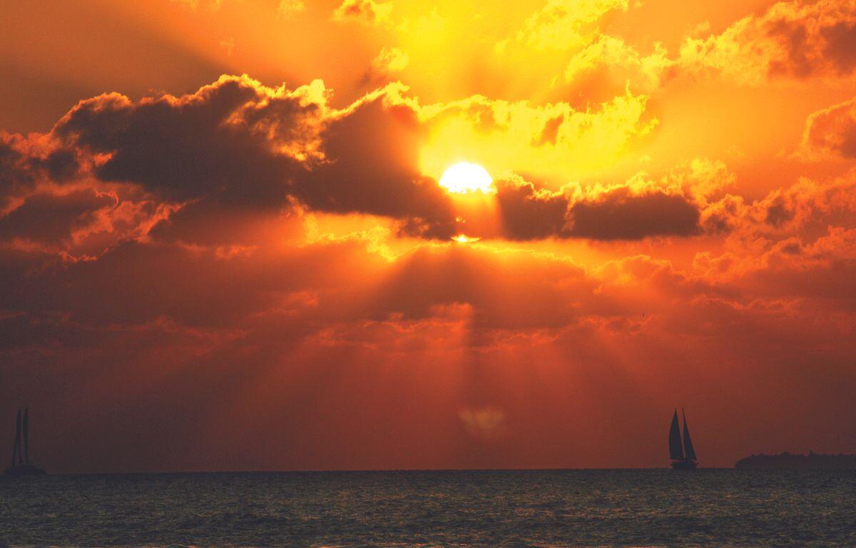 Sun in the clouds near the water