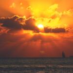 Sun in the clouds near the water