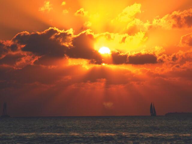 Sun in the clouds near the water