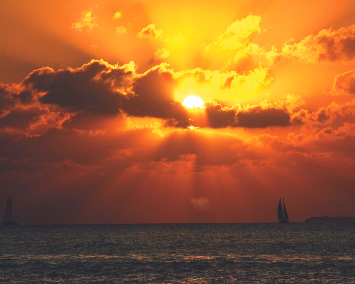 Sun in the clouds near the water