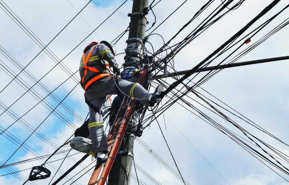 A man working on a power pole.
