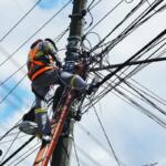 A man working on a power pole.