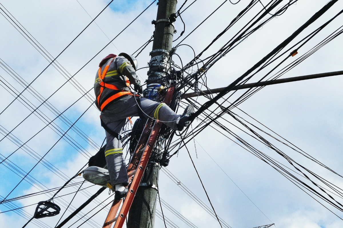 A man working on a power pole.