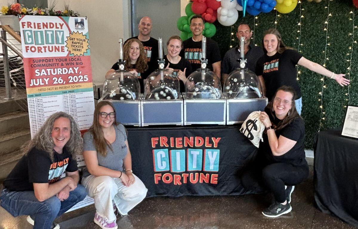HDR team and raffle volunteers pose with BINGO ball machines after the 2025 Friendly City Fortune drawing.