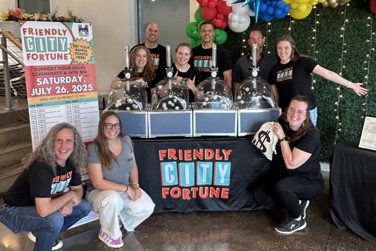 HDR team and raffle volunteers pose with BINGO ball machines after the 2025 Friendly City Fortune drawing.